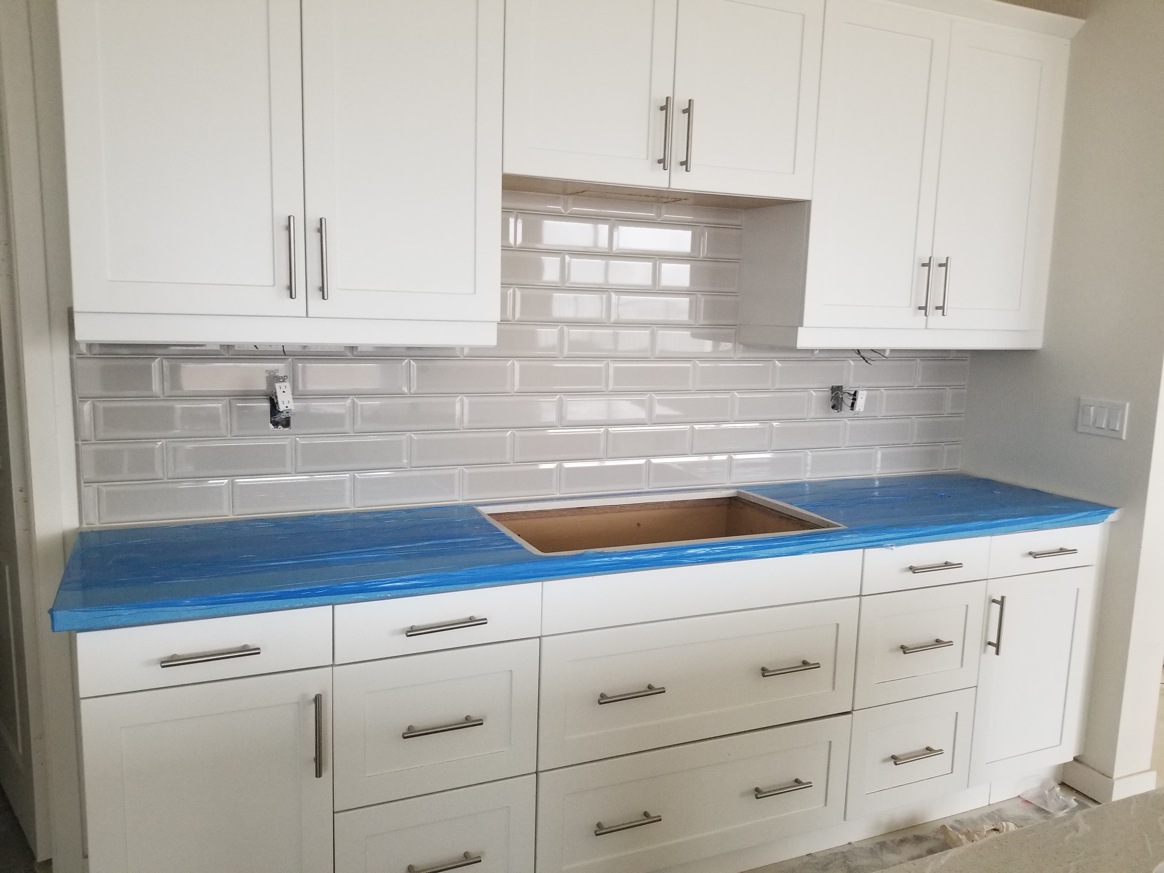 Bright La Quinta kitchen backsplash in clean white subway tile with modern quartz counter