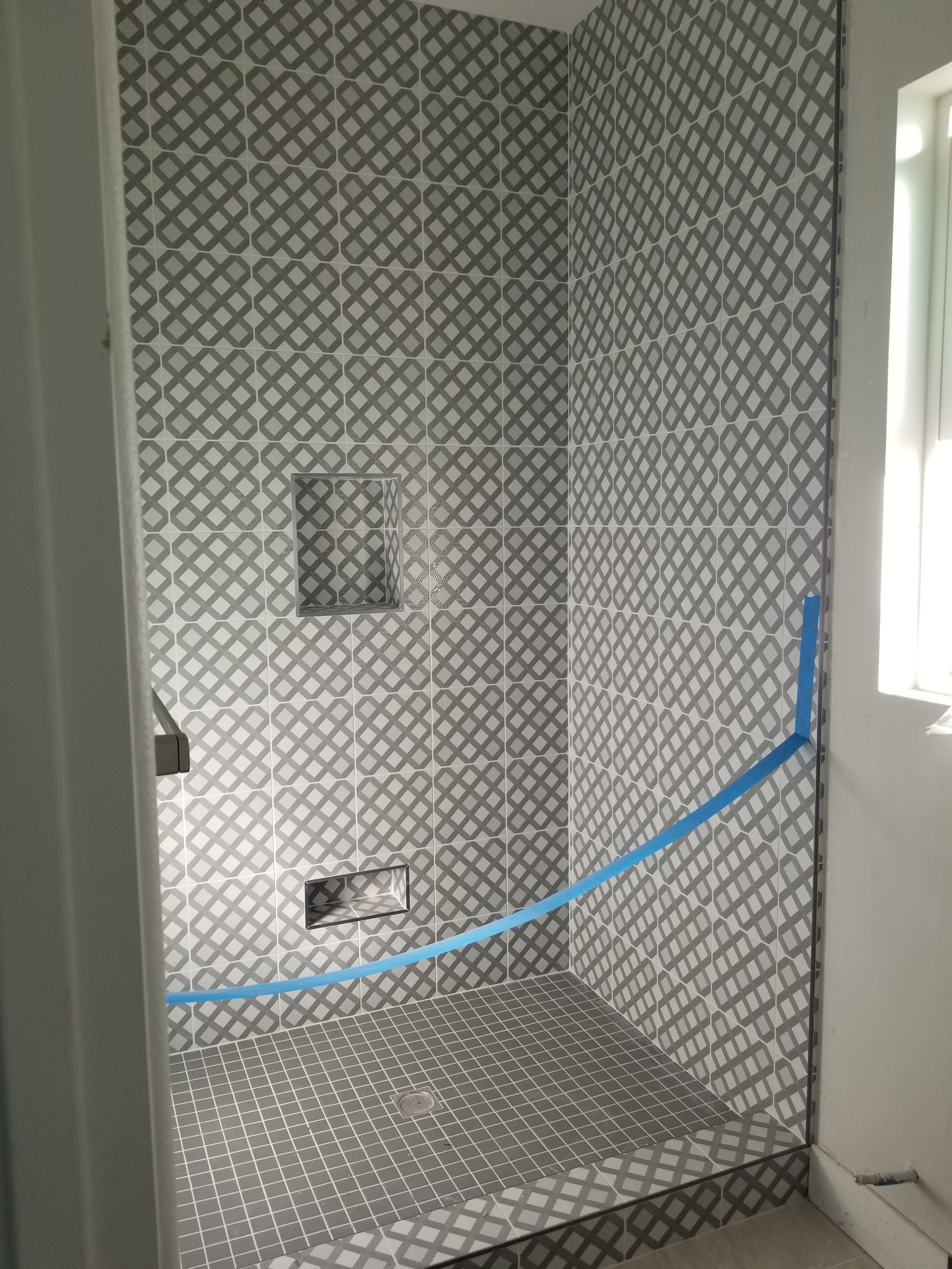 Contemporary La Quinta bathroom floor with geometric white and gray mosaic pattern