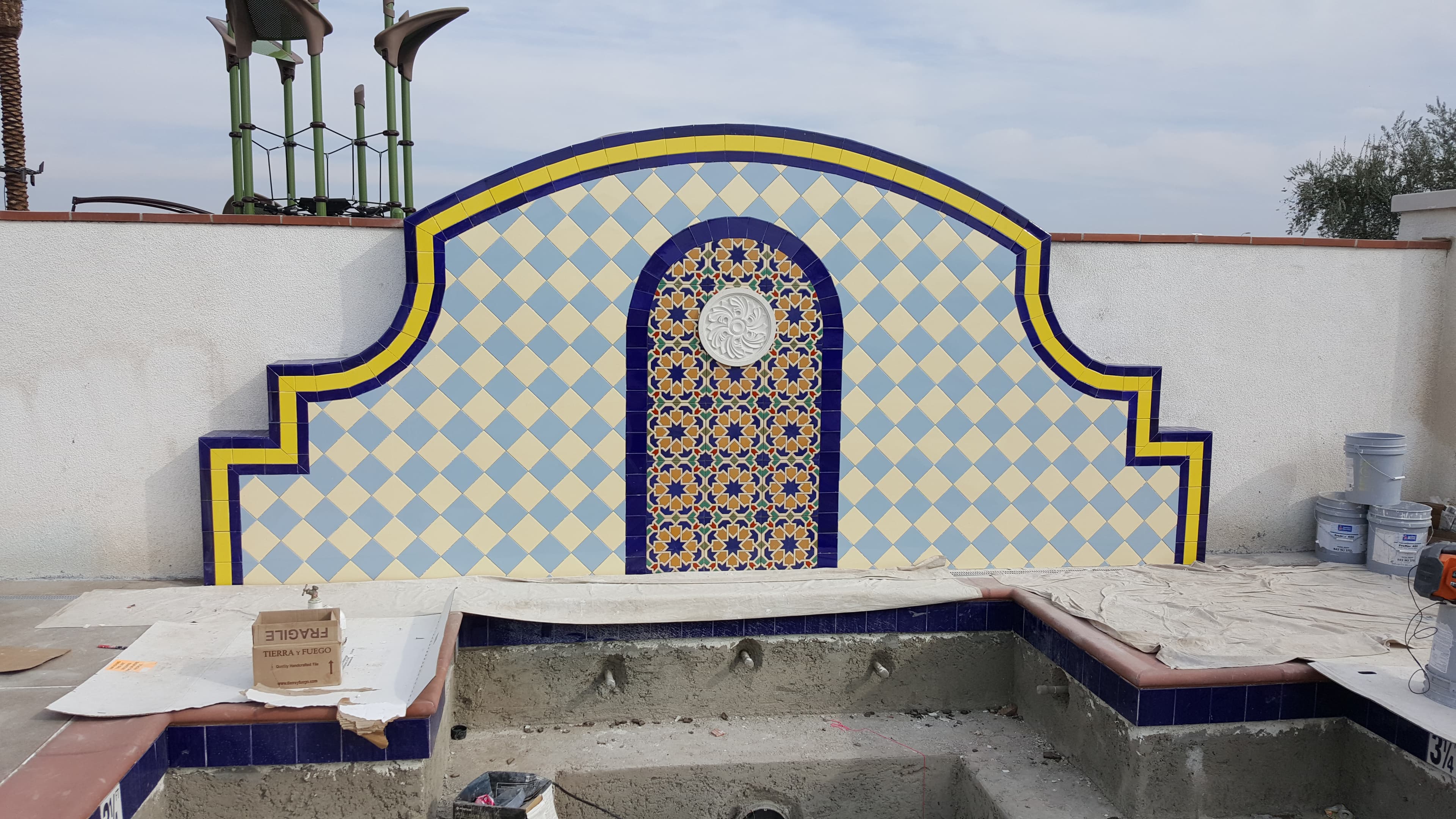 Custom Moroccan-style commercial tile display with yellow and blue geometric pattern, Ontario, CA