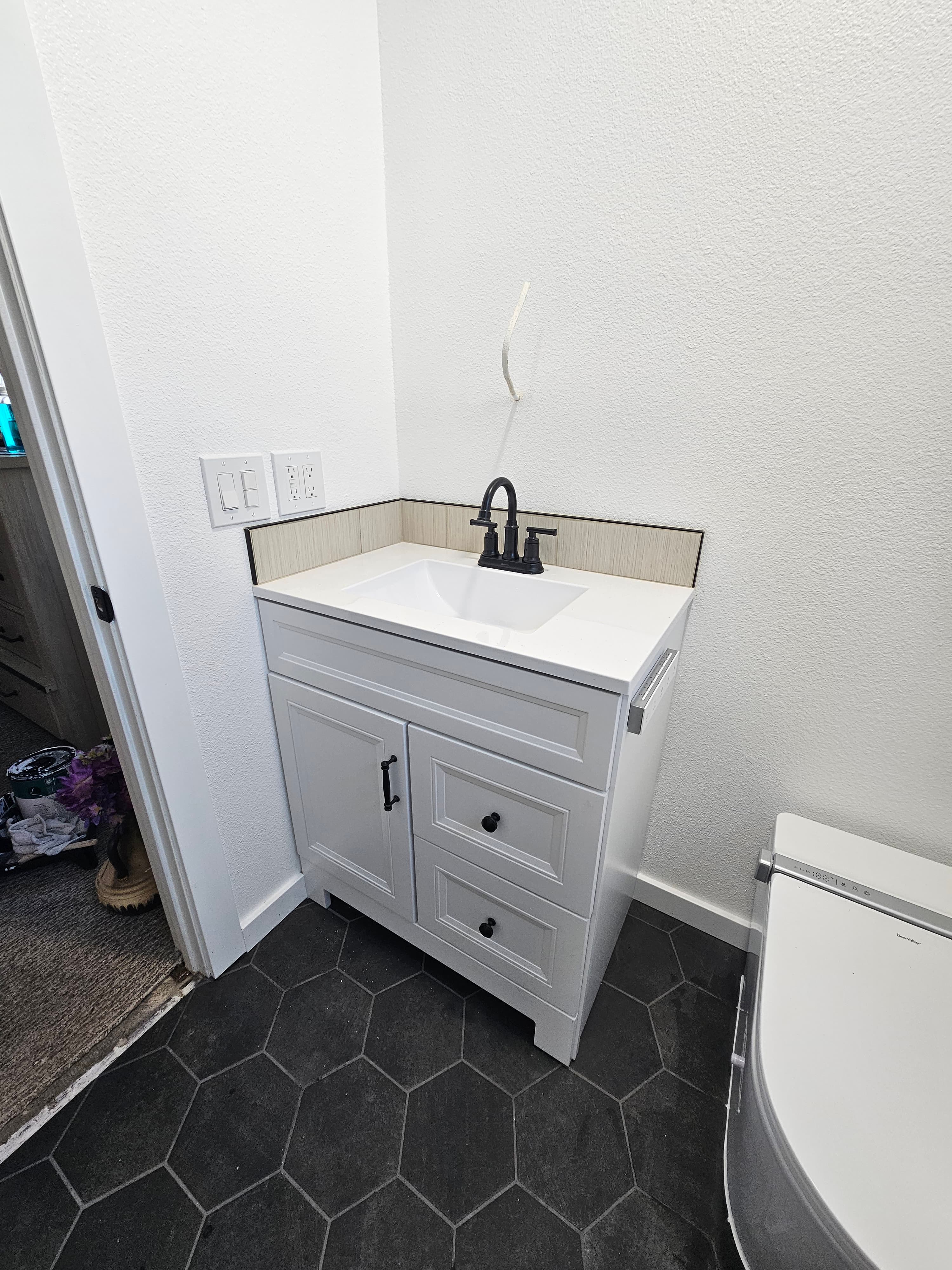 Contemporary Riverside bathroom floor and vanity with geometric tile patterns