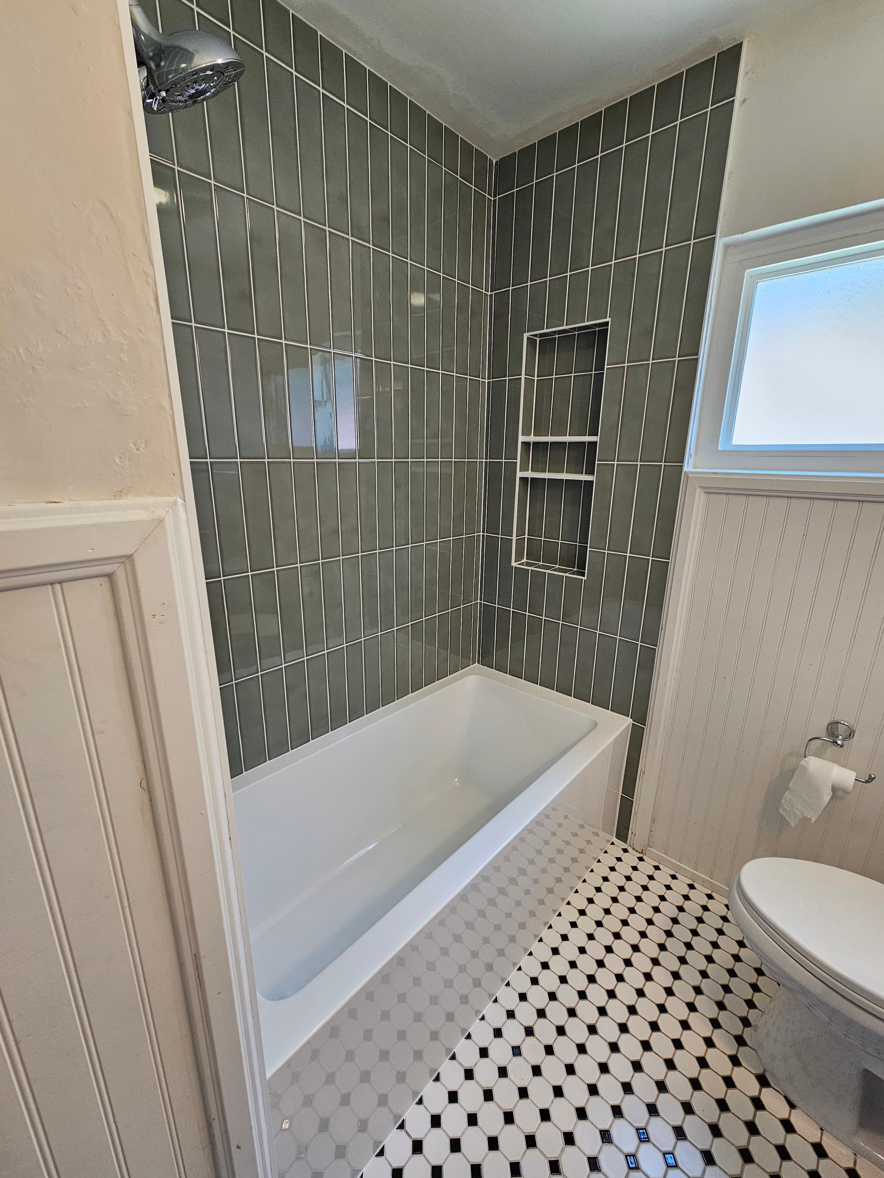 Contemporary San Diego shower with sage green subway walls and black-and-white mosaic floor