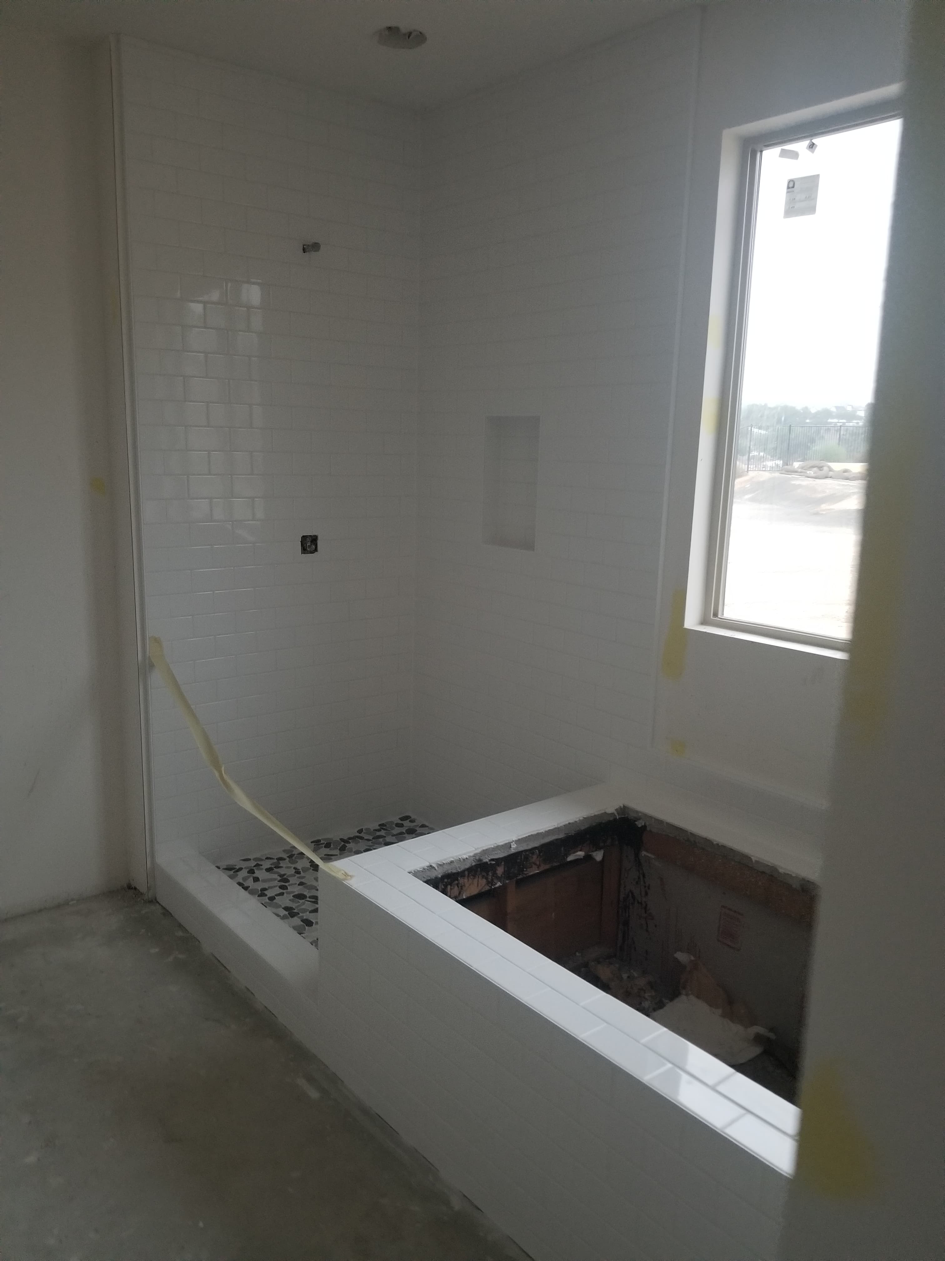 Temecula bathroom in framing stage with skylight installed and drywall prepped for tile install