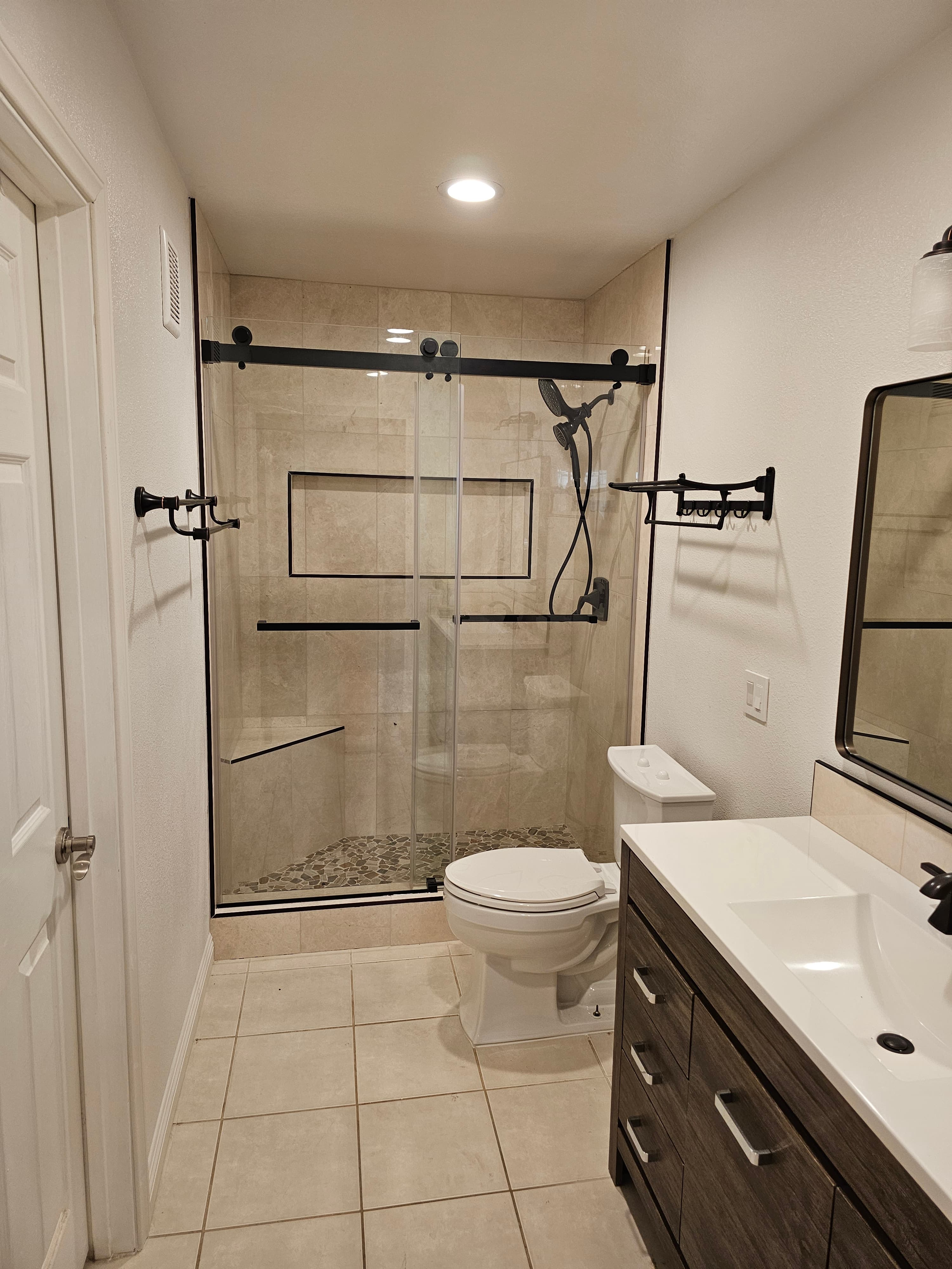Elegant Yorba Linda bathroom with travertine flooring and decorative tile details